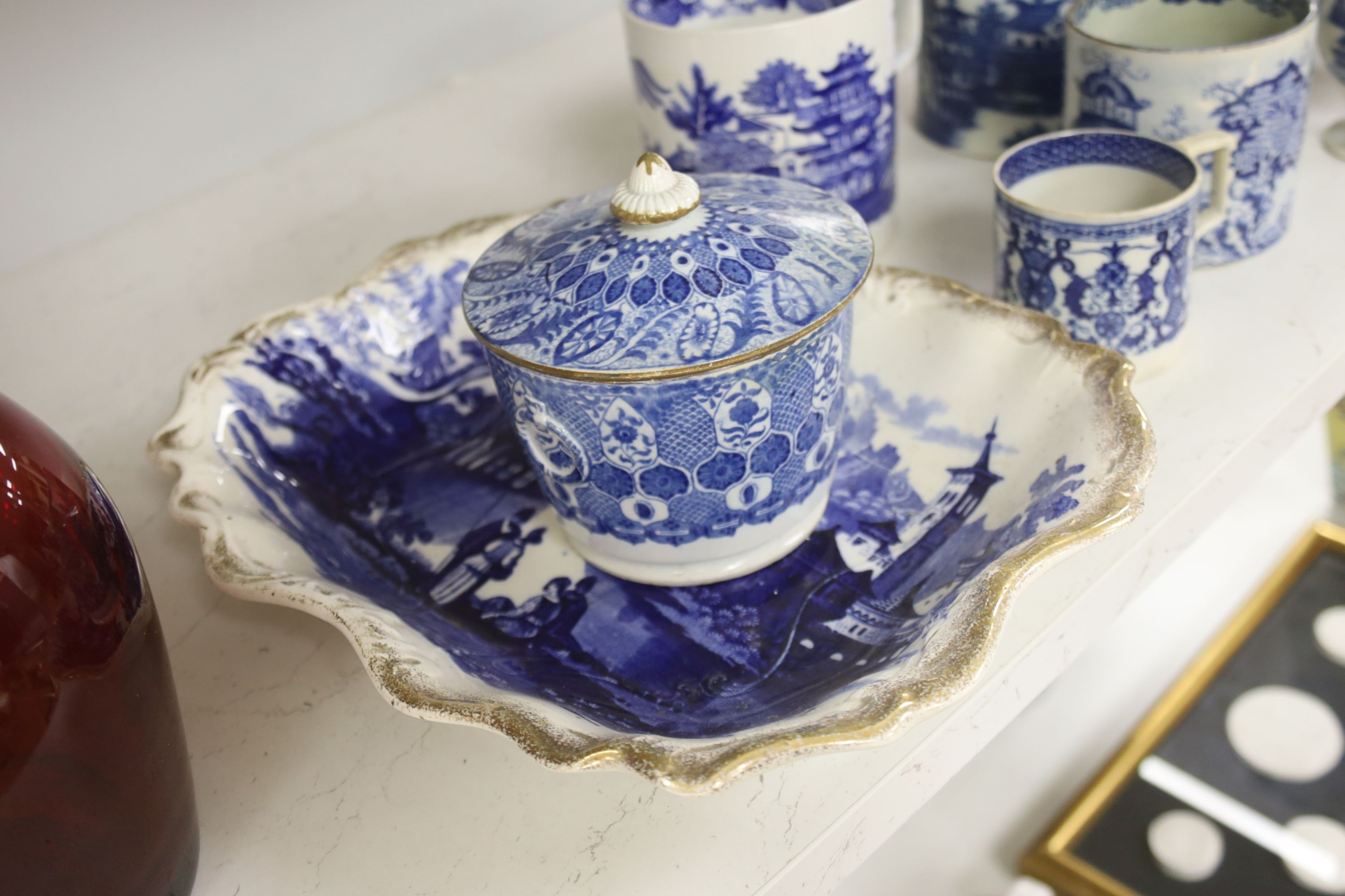 A collection of English blue and white pottery, various dates, comprising a moulded hexagonal teapot and cover, with widow finial, ovoid teapot and cover, lozenge section sugar bowl and cover, with swan finial, circular
